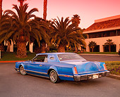 AUT 23 RK0436 06
1979 Lincoln Continental Lowrider Blue 3/4 Rear View On Pavement By Palm Trees And Building Filtered
