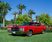 AUT 23 RK0452 03
1970 Chevrolet Chevelle SS 454 Red And Black Stripe 3/4 Low Front View On Grass By Trees Blue Sky