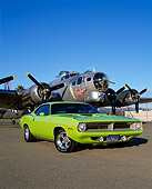 AUT 23 RK0454 09
1970 Plymouth 'Cuda Lime Green Low 3/4 Front View On Pavement By Plane Blue Sky