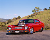 AUT 23 RK0496 06
1972 Chevrolet Nova Prostreet Red 3/4 Front View On Pavement By Grass Hills