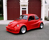AUT 23 RK0511 01
1974 Volkswagen Beetle Custom Red 3/4 Side View On Pavement By Firestation
