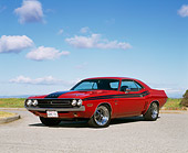 AUT 23 RK0530 02
1971 Dodge Challenger 426 Hemi Red And Black Low 3/4 Front View On Pavement Blue Sky