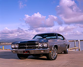AUT 23 RK0550 02
1970 Chevrolet Chevelle 454 SS Gray Black Low 3/4 Front View On Pavement By Water Clouds