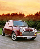AUT 23 RK0662 04
1972 Canadian Austin Mini 1000 Burgundy With White Stripes 3/4 Front View On Pavement Trees Filtered