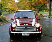 AUT 23 RK0663 02
1972 Canadian Austin Mini 1000 Burgundy With White Stripes Head On Shot On Pavement By Fall Trees