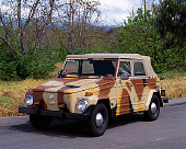 AUT 23 RK0749 01
1973 VW Thing 181 Camouflage 3/4 Front View On Pavement By Trees Grass Sky