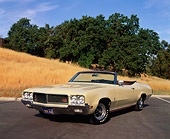 AUT 23 RK0858 01
1970 Buick GS455 Convertible Yellow 3/4 Front View On Pavement By Dry Grass Hill And Trees