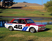 AUT 23 RK0864 03
1971 Datsun BRE 510 Race Car 3/4 Front View On Grass By Water