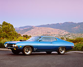 AUT 23 RK0947 02
1970 Ford Torino Cobra SCJ Blue 3/4 Side View On Pavement By Trees At Dusk