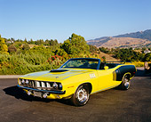 AUT 23 RK0948 03
1971 Plymouth Hemi Cuda Convertible Yellow And Black 3/4 Front View On Pavement By Trees