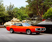 AUT 23 RK0952 03
1971 Dodge Charger 500 Orange 3/4 Side View On Pavement By Military Tanks