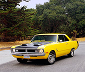 AUT 23 RK0977 02
1972 Dodge Dart Swinger Yellow And Black 3/4 Front View On Pavement By Trees