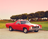 AUT 23 RK1018 05
1972 Chevrolet, El Camino SS, Red White Stripe 3/4  Side View On Pavement By Grass And Trees At Sunset