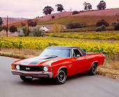 AUT 23 RK1023 05
1972 Chevrolet, El Camino SS, Orange Black Stripe 3/4 Front View On Pavement By Vineyard
