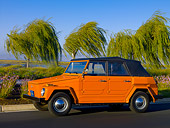 AUT 23 RK1055 01
1974 Volkswagen Thing Type 181 Orange Low 3/4 Side View On Pavement By Trees