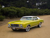 AUT 23 RK1128 01
1972 Chevrolet Monte Carlo Candy Lime Gold 3/4 Front View On Dirt Trees Background