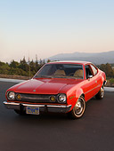 AUT 23 RK1579 01
1974 AMC Hornet Hatchback Red 3/4 Front View On Pavement By Mountains Trees