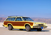 AUT 23 RK1597 01
1977 Ford Pinto Wagon Chartreuse With Woodgrain Side Paneling 3/4 Front View On Pavement By Hills Sky