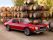 AUT 23 RK1603 01
1974 Chevrolet Camaro Z-28 Red 3/4 Front View On Gravel By Wine Barrels