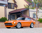 AUT 23 RK1656 01
1973 Datsun 240Z Orange 3/4 Front View On Driveway By House