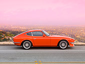 AUT 23 RK1660 01
1972 Datsun 240Z Orange Profile View On Road Overlooking City Lights