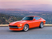 AUT 23 RK1663 01
1972 Datsun 240Z Orange 3/4 Front View On Road Overlooking Valley