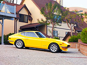 AUT 23 RK1672 01
1973 Datsun 240Z Yellow 3/4 Front View On Driveway By House