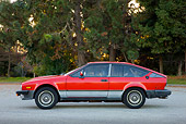 AUT 23 RK1735 01
1981 Alfa Romeo GTV6 Coupe Red Profile View On Pavement By Trees