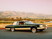 AUT 24 RK0116 01
1984 Cadillac Coupe Deville Lowrider Green 3/4 Side View On Pavement Mountains Filtered