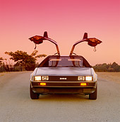 AUT 24 RK0016 01
1980's Delorean Silver Head On Doors Open On Pavement Pink Sky