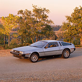 AUT 24 RK0025 01
1980's Delorean Silver 3/4 Side View On Pavement Trees Background