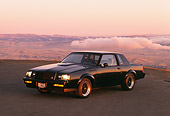 AUT 24 RK0059 02
1987 Buick GNX Black 3/4 Front View On Pavement Sunset Background
