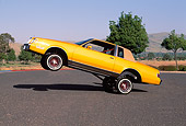 AUT 24 RK0105 08
1982 Buick Regal Lowrider Orange 3/4 Front View On Pavement Trees Blue Sky