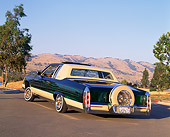 AUT 24 RK0113 01
1984 Cadillac Coupe Deville Lowrider Green 3/4 Rear View On Pavement Trees Mountains