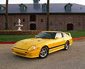 AUT 24 RK0146 04
1982 Nissan 280ZX Full Custom Yellow 3/4 Front View On Gravel By Grass And Brick Building