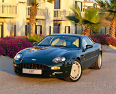 AUT 25 RK0360 01
1995 Aston Martin DB7 Green Front 3/4 View On Pavement By Building