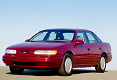 AUT 25 RK0495 02
1993 Ford Taurus Burgundy Side 3/4 View On Pavement Hill Blue Sky