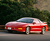 AUT 25 RK0842 11
1993 Pontiac Firebird Trans Am Red 3/4 Front View On Road By Bushes
