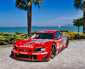 AUT 25 RK1371 05
1999 Nissan Skyline Nismo Race Car Red 3/4 Front View By Water And Palm Trees