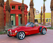 AUT 25 RK0033 02
1997 Panoz A.I.V Roadster Red 3/4 Side View On Cement By Building And Palm Trees