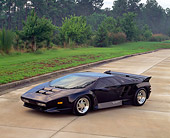 AUT 25 RK0105 14
1993 Vector W8 Twin Turbo Black 3/4 Side View On Pavement By Grass And Trees