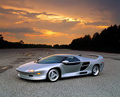 AUT 25 RK0130 06
1996 Vector M-12 Silver 3/4 Side View On Pavement By Trees Lights On Cloudy Sky