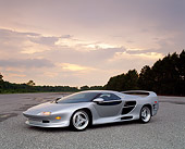 AUT 25 RK0130 07
1996 Vector M-12 Silver 3/4 Side View On Pavement By Trees Lights On Cloudy Sky