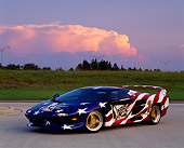 AUT 25 RK0167 07
1996 Vector M-12 Patriotic Side 3/4 View On Pavement Grass Hill