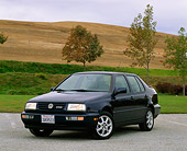 AUT 25 RK0185 04
1997 Volkswagen Jetta GLX Black 3/4 Front View On Pavmement By Grass Hills