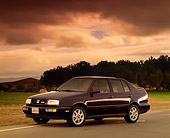 AUT 25 RK0190 03
1997 Volkswagen Jetta GLX Black 3/4 Side View On Pavement Trees Filtered