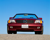 AUT 25 RK0222 01
1991 Mercedes-Benz 500SL Convertible Burgundy Low Head On Shot On Pavement Blue Sky