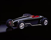 AUT 25 RK0284 04
1996 California V-8 Special Black Roadster Custom Black 3/4 Side View On Black Floor Studio
