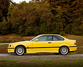 AUT 25 RK0414 03
1995 BMW M3 Yellow Profile View On Gravel By Trees