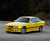 AUT 25 RK0424 02
1995 BMW M3 Yellow 3/4 Front View On Pavement At Dusk